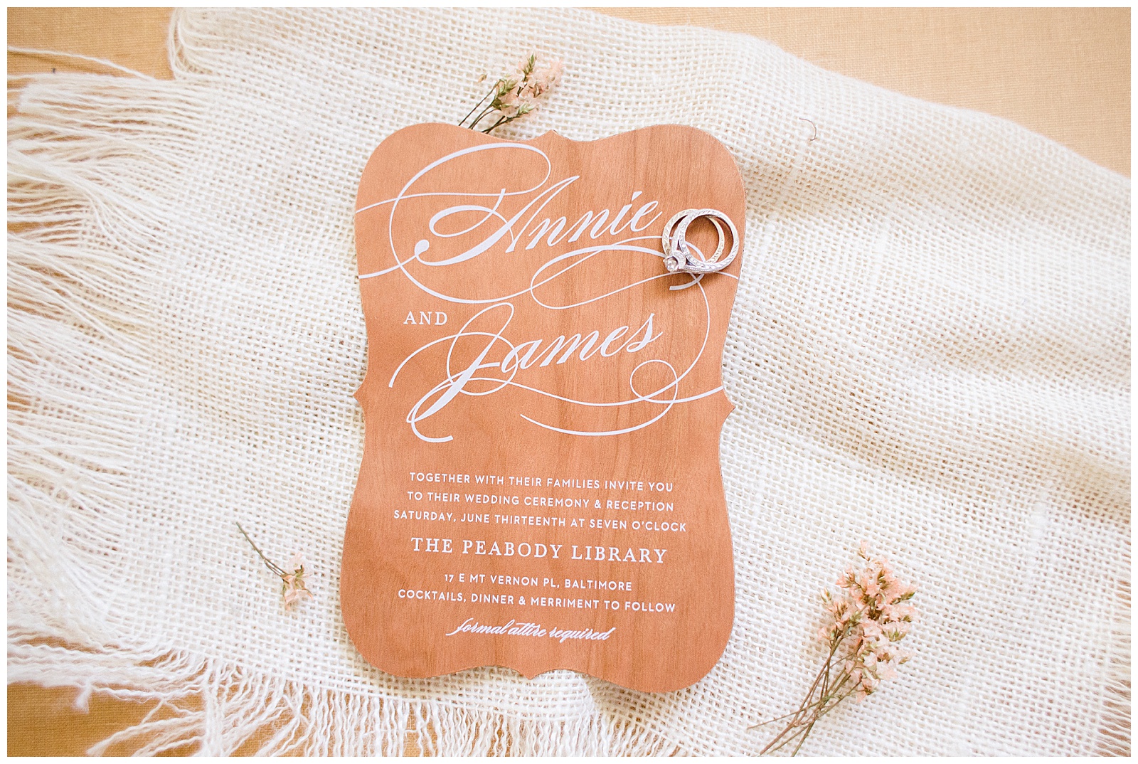 rustic real wood wedding invitation with accented pink flowers